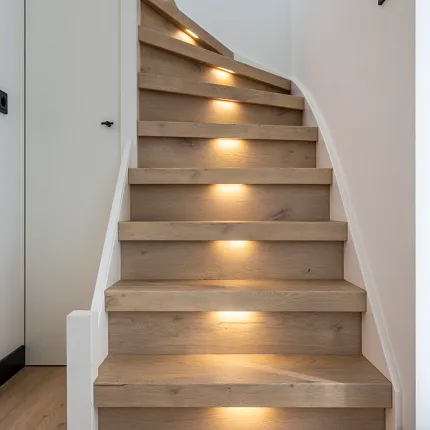 Modern staircase with oak hardwood flooring and integrated lighting