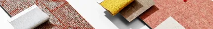 Education Facility Flooring Swatches with Commercial Carpet Tiles and Educational Items Assorted flooring swatches including commercial carpet tiles in yellow, gray, red, and green, with educational items like a notebook, pen, and geometric shapes