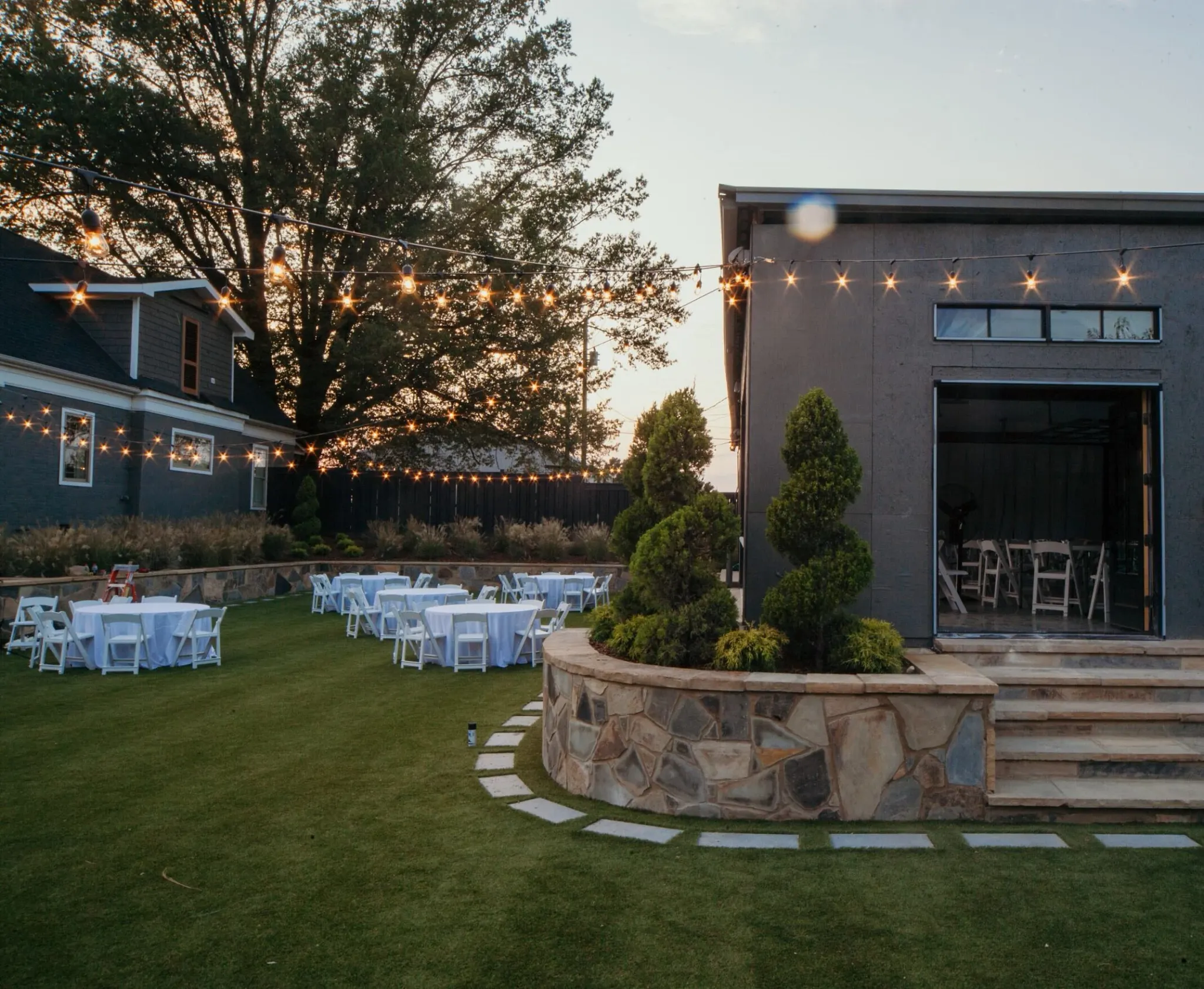 Outdoor event space with string lights and seating