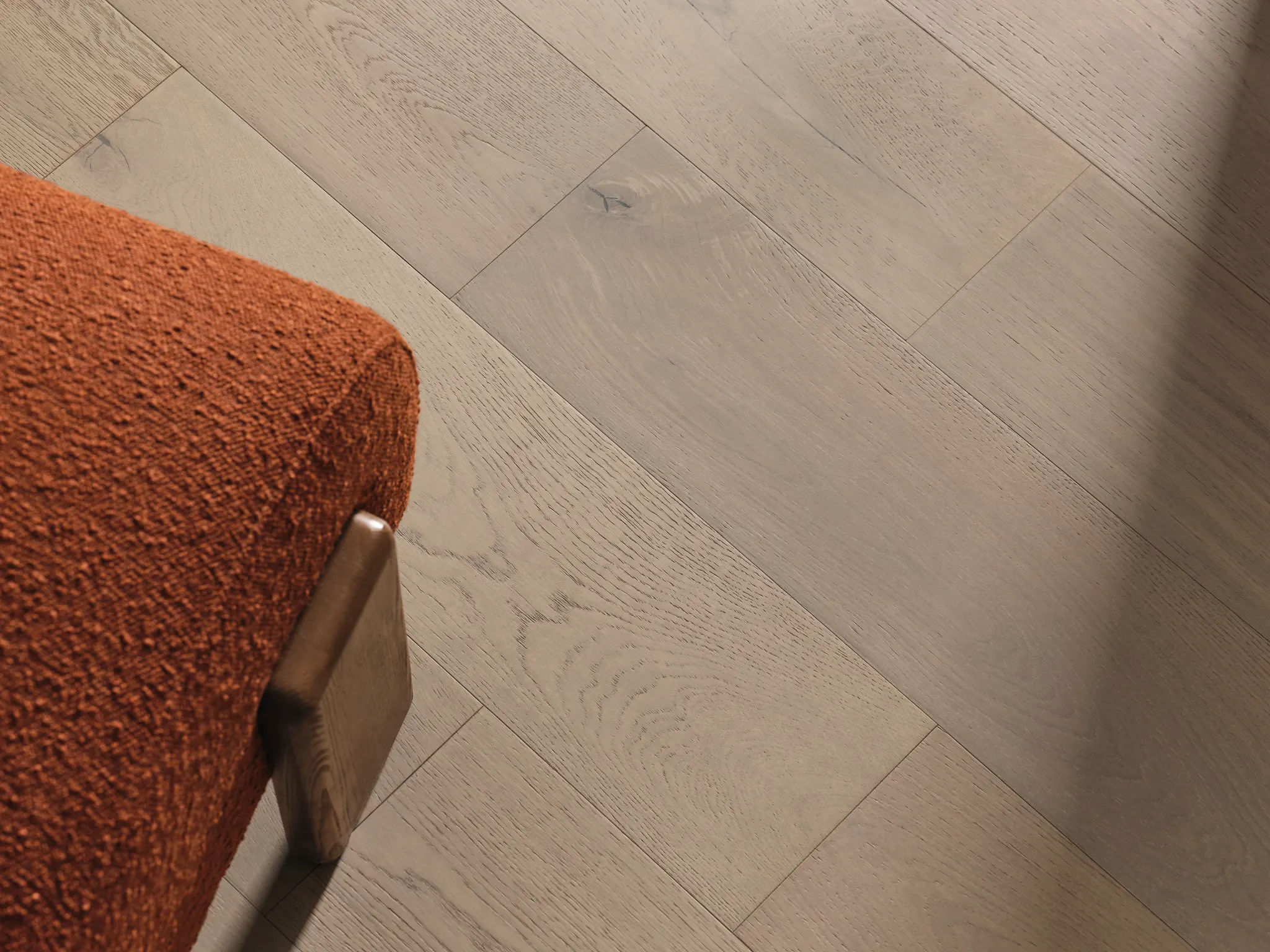 Light oak hardwood flooring with orange upholstered chair