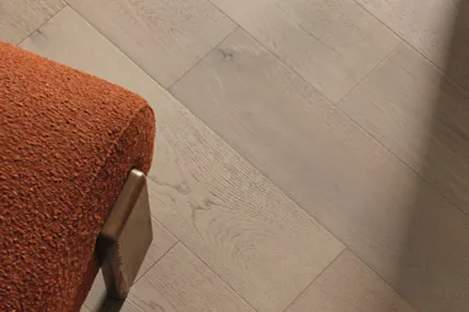 Stylish light oak flooring for modern interiors Light oak hardwood flooring with orange upholstered chair