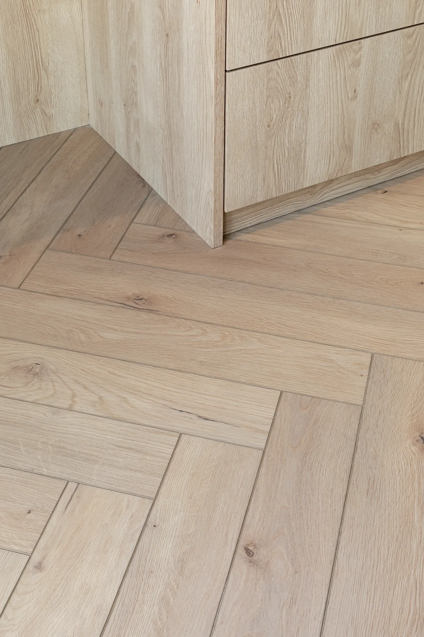 Close-up natural light wooden erringbone floor from Coretec