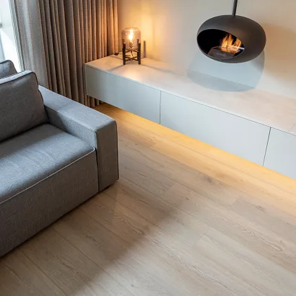 Light oak hardwood flooring in a modern living room with a fireplace