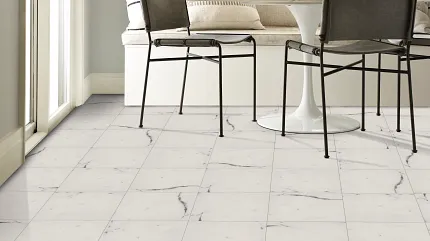 Elegant Marble-Look Tile Flooring in Contemporary Dining Space Modern dining area with white marble-look tile flooring and black metal chairs