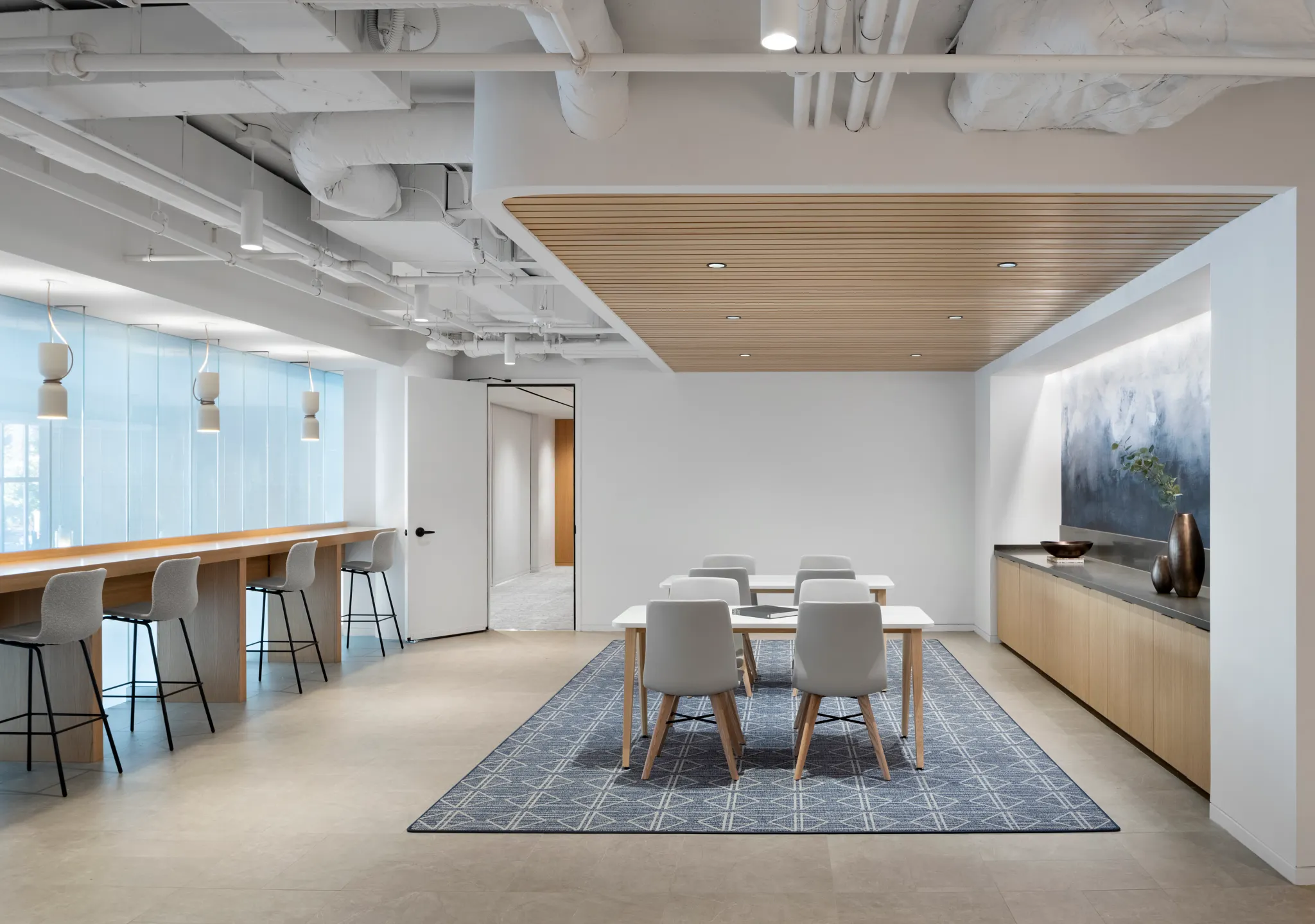 Modern workplace with a 12x15 ft area rug featuring a geometric pattern
