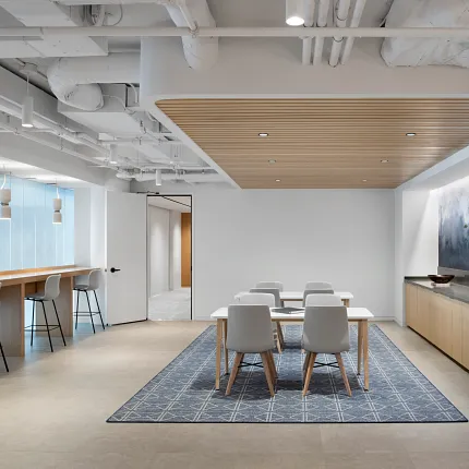 Modern workplace with a 12x15 ft area rug featuring a geometric pattern