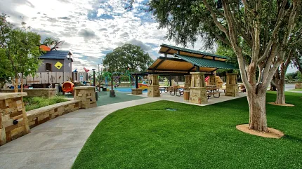 Beautiful outdoor park setting with play structures Scenic park with playground and picnic area