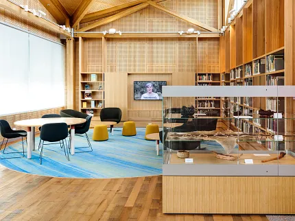 University of Tasmania Library Learning Environment and Cultural Display | Shaw Contract University of Tasmania library learning space featuring custom blue patterned flooring, collaborative seating and a cultural display showcasing local artefacts.