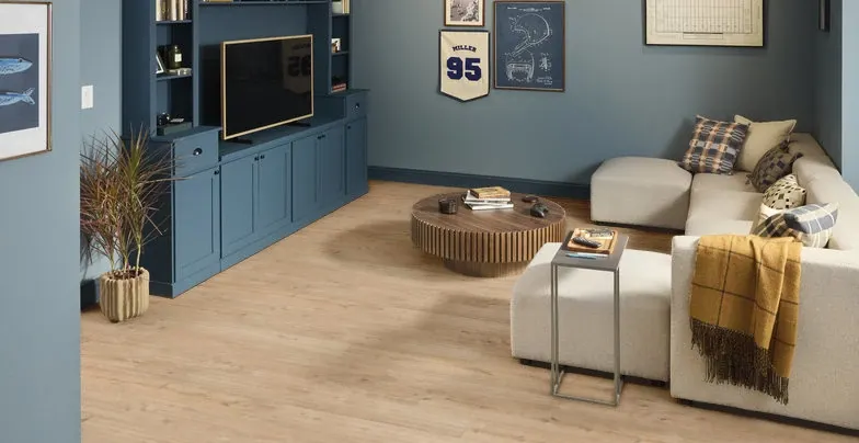 Cozy living room with light wood flooring and blue cabinetry