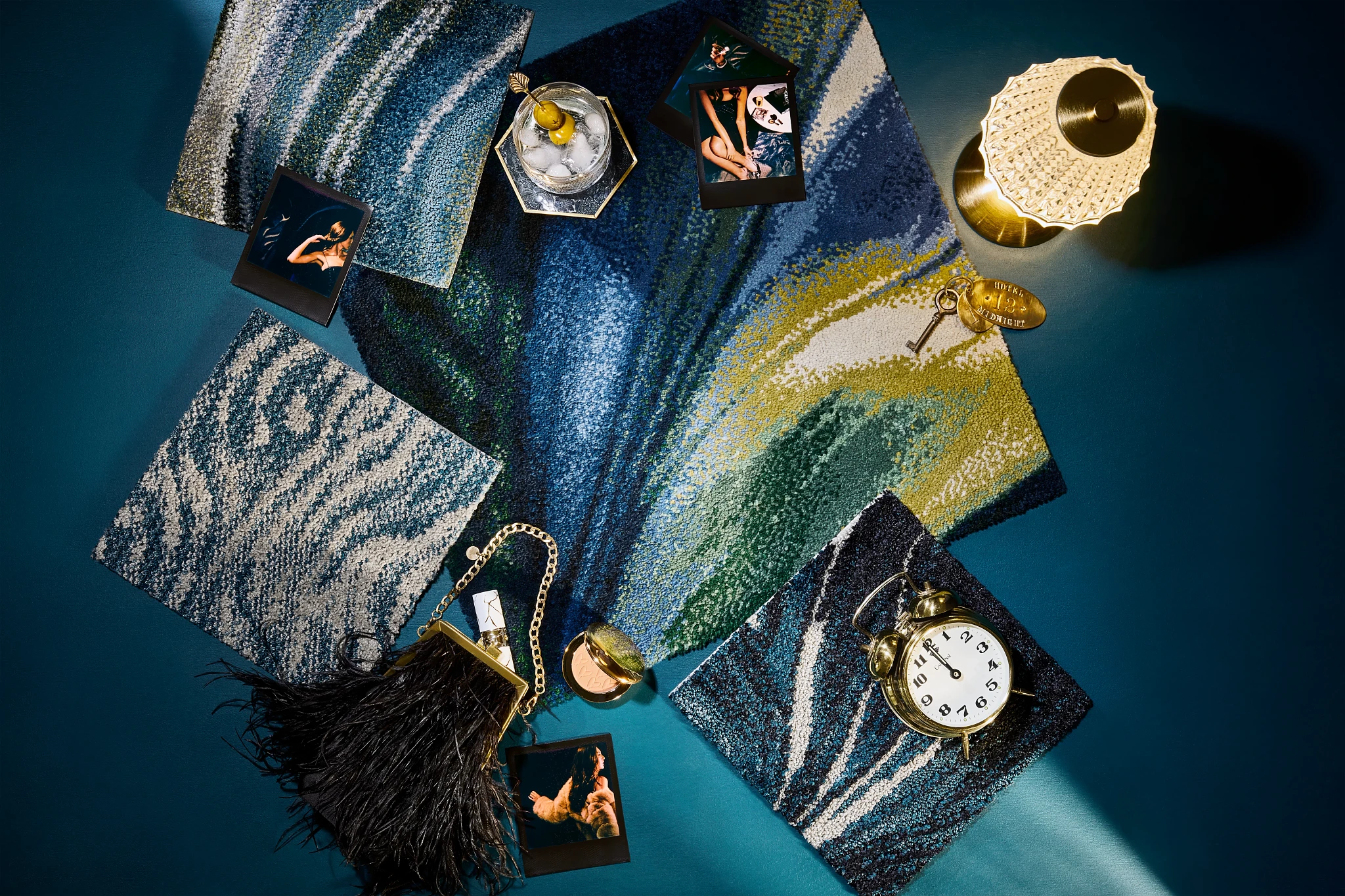 Swatch of commercial carpet tiles in blue, green, and yellow hues with decorative items including a clock and photographs