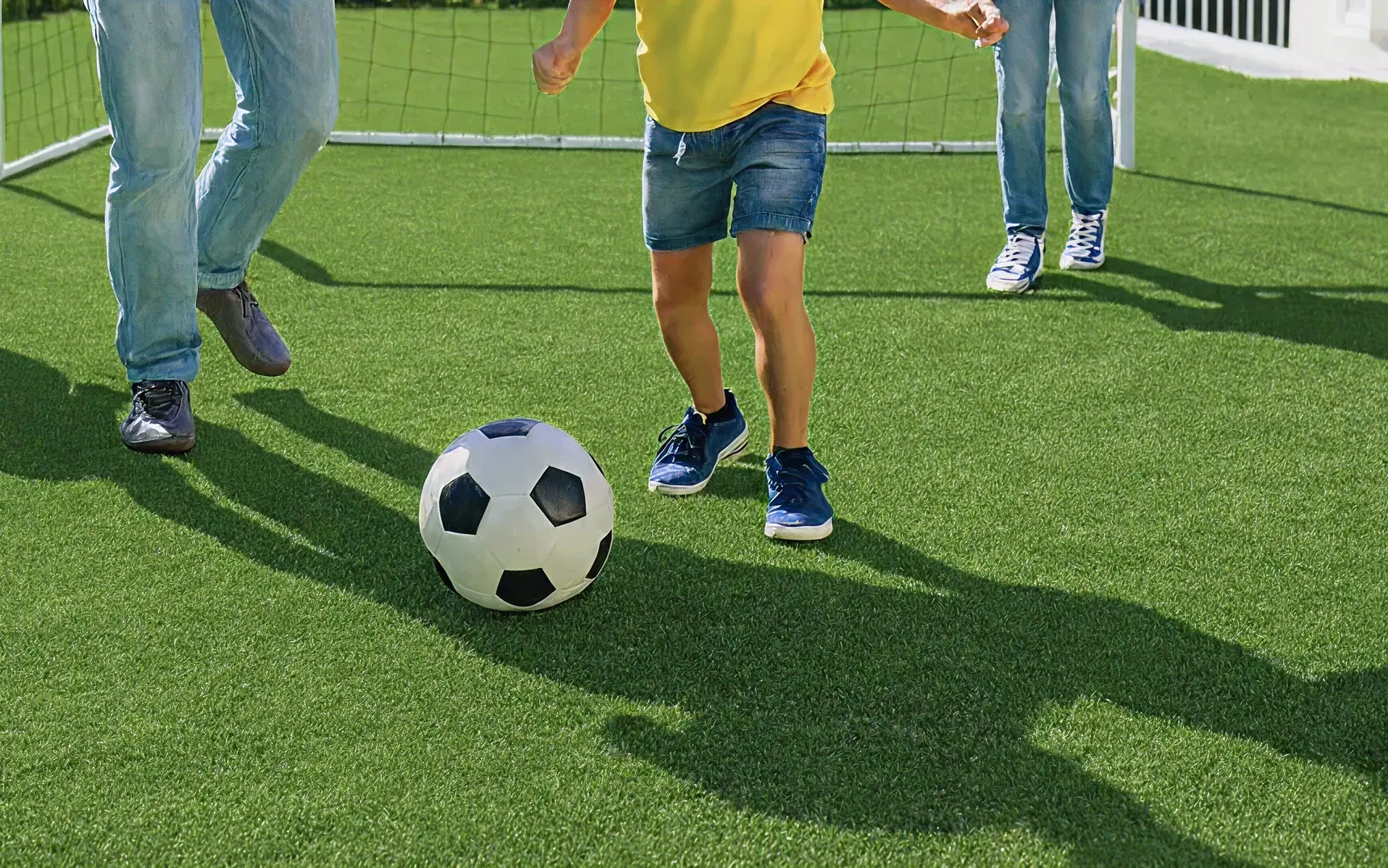 Children playing soccer on artificial grass