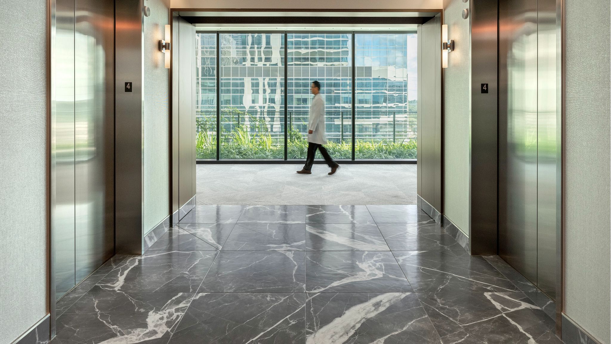 A doctor walking across the hallway in the medical center