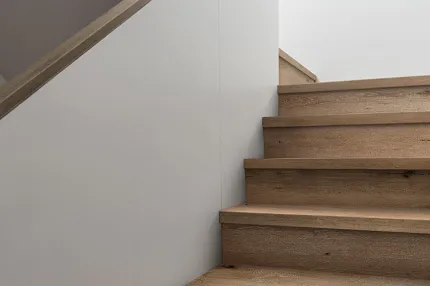 Light Oak Wood Look Luxury Vinyl Plank Flooring in Modern Hallway Modern residential hallway with light oak wood look luxury vinyl plank flooring and illuminated steps