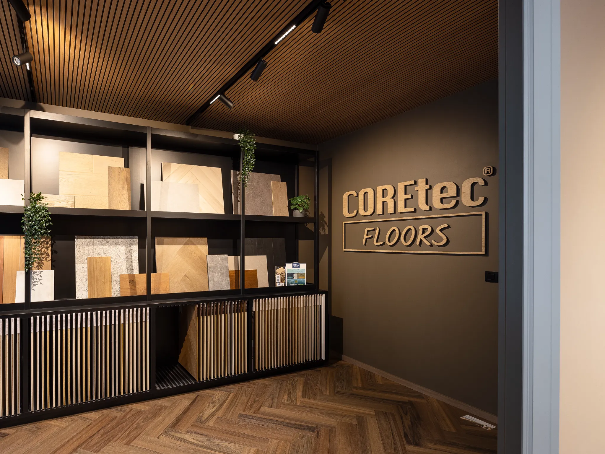 Modern showroom with COREtec Floors display featuring various luxury vinyl plank and tile samples in wood and stone looks