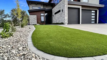 Contemporary home design with stylish outdoor elements Modern house exterior with stone landscaping and green lawn