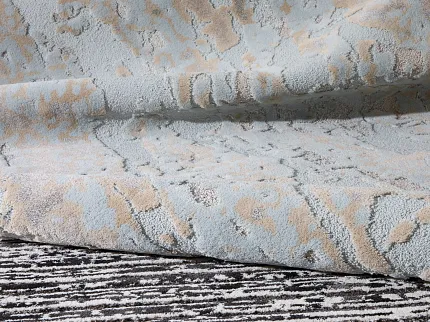 Light Blue and Beige Textured Carpet Swatch - Premium Flooring Collection Close-up of a textured carpet swatch in light blue and beige colors