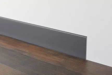 Dark Wood Flooring with Gray Baseboard Dark wood flooring with gray baseboard against a white wall