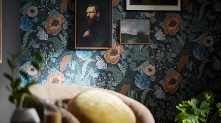 Floral wallpaper and art Floral wallpaper with framed art on wall and furniture in foreground
