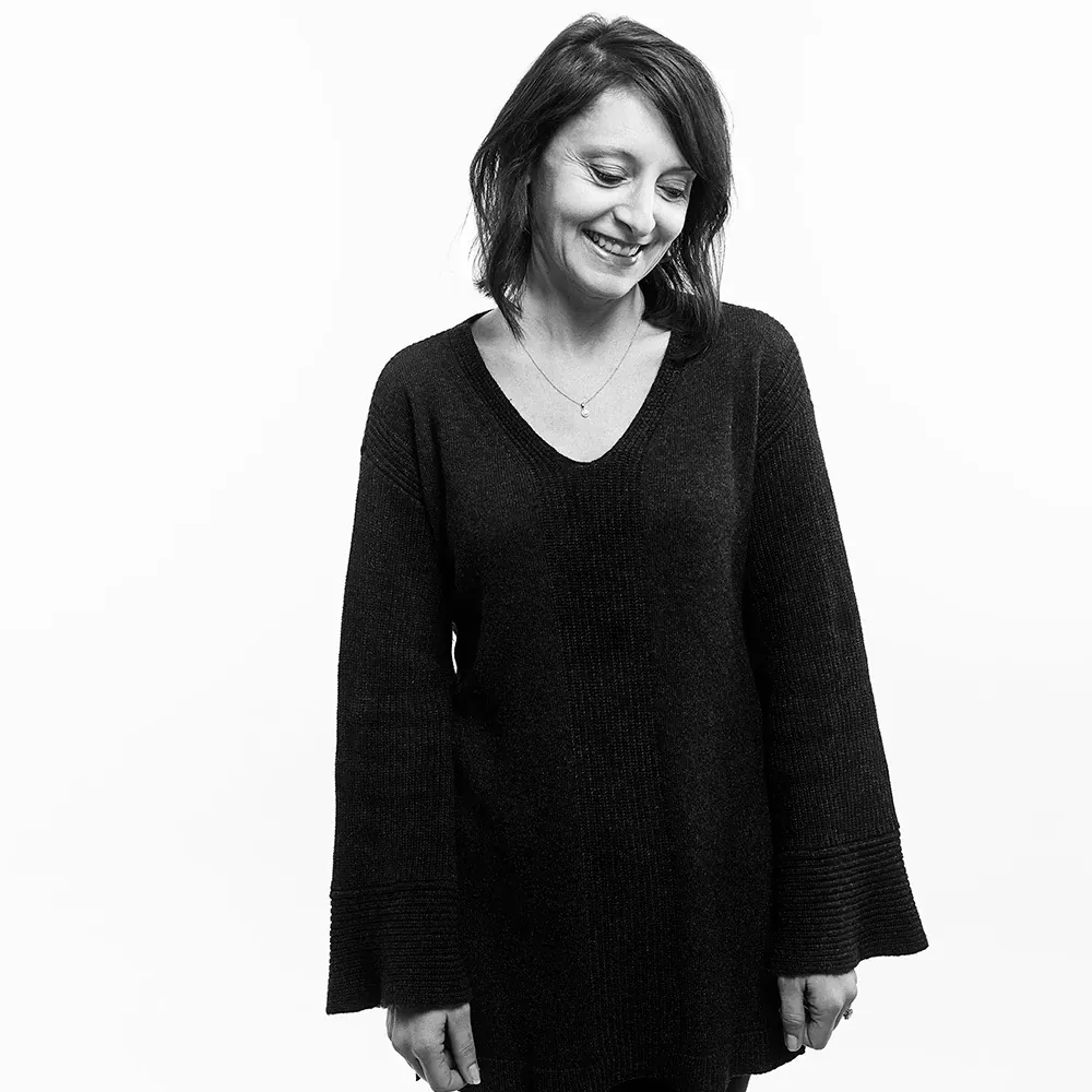 Woman in black sweater with a blurred face
