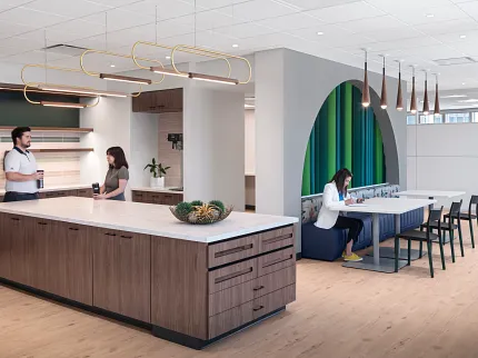 Stylish office kitchen design with elegant wood flooring Modern workplace kitchen with light wood flooring and contemporary furniture