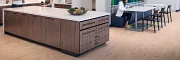 Stylish office kitchen design with elegant wood flooring Modern workplace kitchen with light wood flooring and contemporary furniture