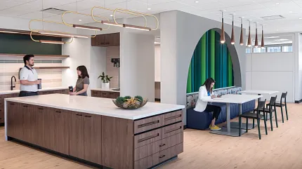 Stylish office kitchen design with elegant wood flooring Modern workplace kitchen with light wood flooring and contemporary furniture