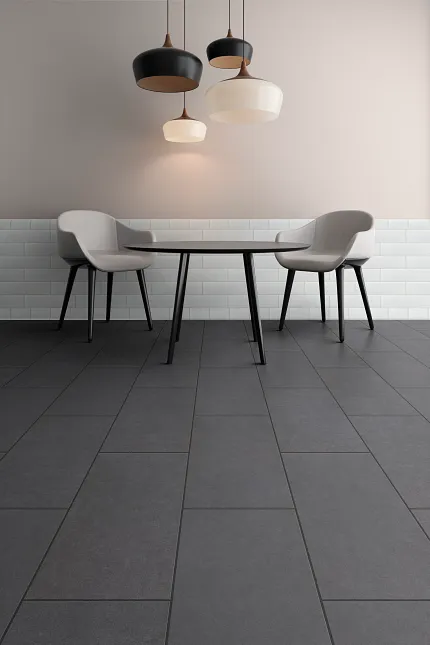 Contemporary dining room with dark grey commercial ceramic tile flooring and stylish lighting fixtures