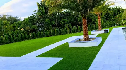 Elegant garden design with lush greenery and stone paths Outdoor landscape with palm trees and stone pathways