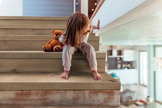 Child on COREtec staircase with teddybear