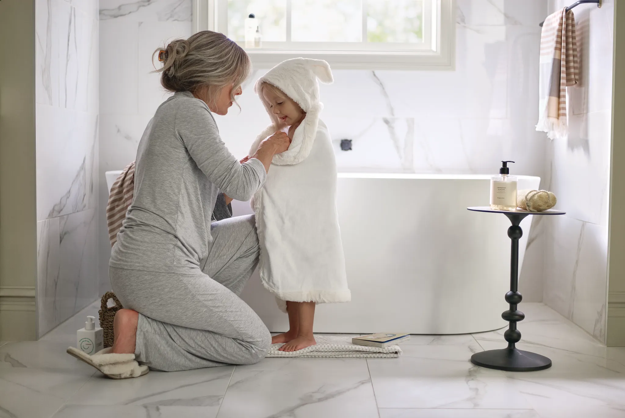 Cozy bathroom scene with elegant white marble tile flooring, showcasing a serene and comfortable home environment