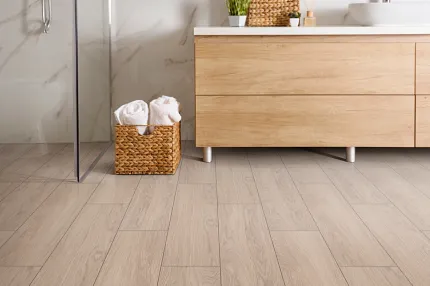Light Wood Laminate Flooring in Contemporary Bathroom Setting Modern bathroom with light wood laminate flooring and natural wood vanity