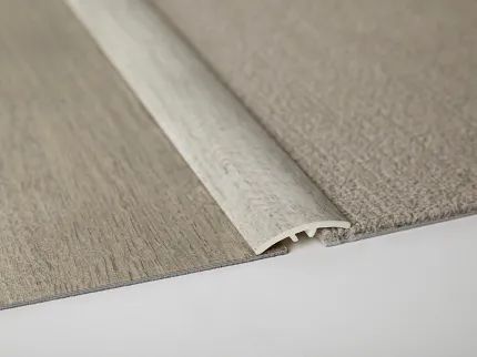 Flooring Transition Strip for Seamless Flooring Integration Flooring transition strip between light wood and beige carpet