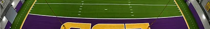 Artificial turf football field with LSU logo in purple and gold colors