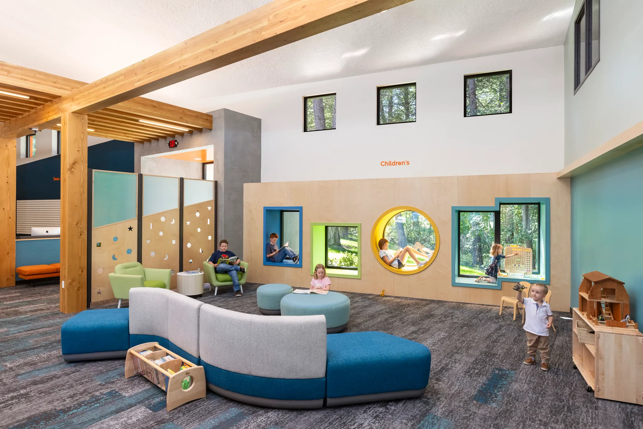 Modern children's education facility with colorful seating and play areas, featuring commercial carpet tile flooring in a vibrant, playful design.