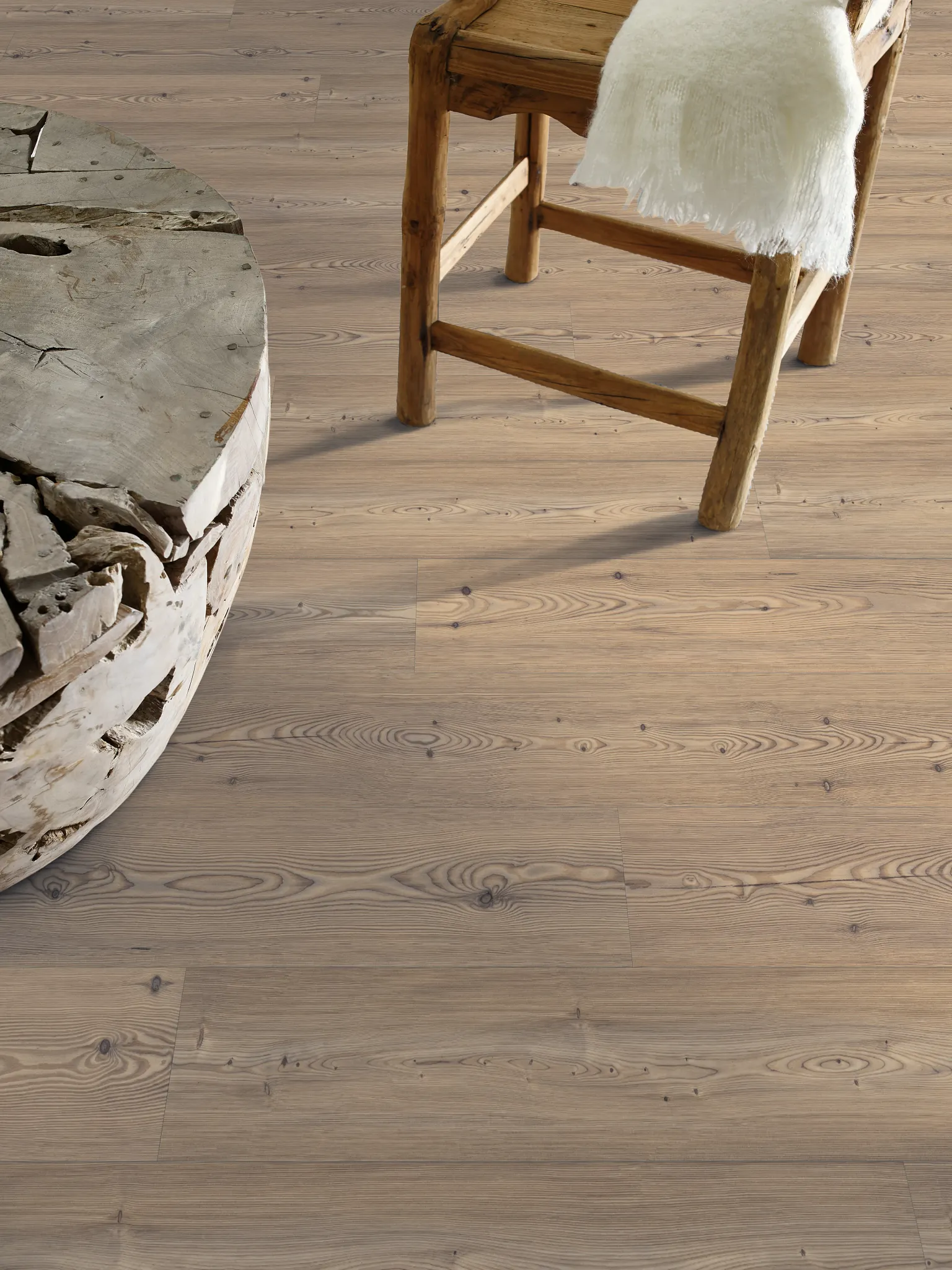 Rustic wooden stool and natural wood table on light oak laminate flooring