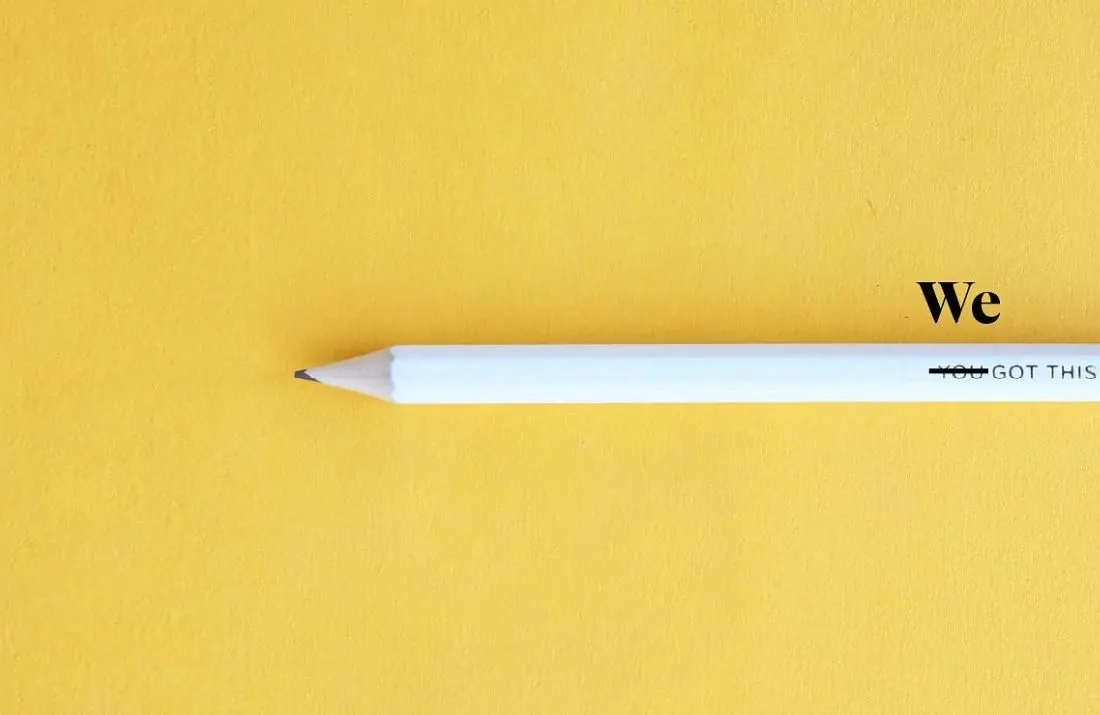 White pencil on yellow background with motivational text "We Got This"