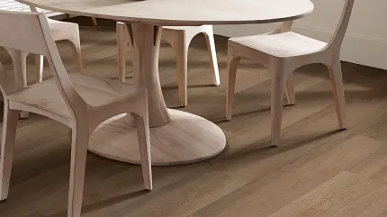 Elegant Hardwood Flooring in a Contemporary Dining Room Setting Modern dining room with light wood furniture and durable hardwood flooring