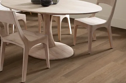 Elegant Hardwood Flooring in a Contemporary Dining Room Setting Modern dining room with light wood furniture and durable hardwood flooring