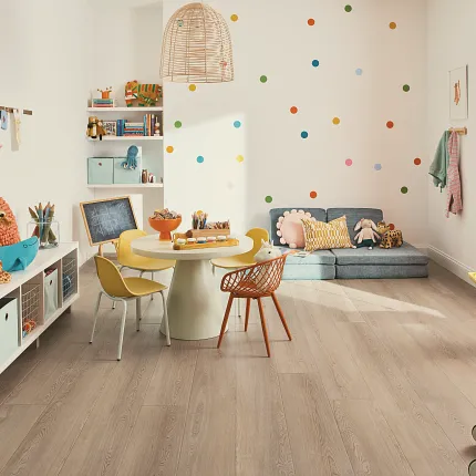 This COREtec product features Soft Step, our newest attached underlayment. childrens playroom with polka dotted walls, small table, chalkboard, shelves with toys and wood look vinyl flooring