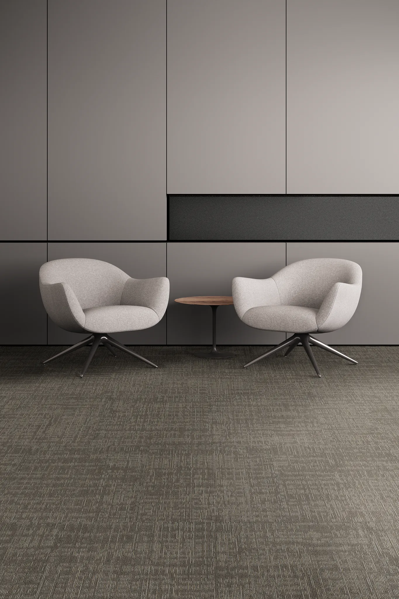 Modern lounge area with two gray armchairs and a small round table on dark gray commercial carpet tile