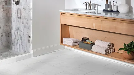 White Stone Look Luxury Vinyl Tile Flooring in Modern Bathroom - 24x12 inch Modern bathroom with white stone look luxury vinyl tile flooring, featuring a wooden vanity and glass shower