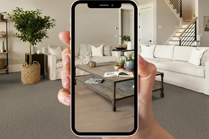 A hand holding a smartphone in their room to visualize flooring A hand holding a smartphone in their room to visualize flooring