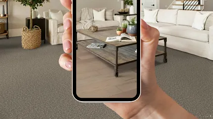 A hand holding a smartphone in their room to visualize flooring A hand holding a smartphone in their room to visualize flooring