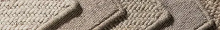 Swatches of 100% wool carpet in various neutral tones including beige, taupe, and cream