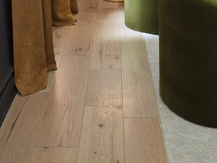 Light Oak Engineered Hardwood Flooring in a Cozy Living Room Setting Cozy living room with light oak engineered hardwood flooring, featuring green velvet chairs and beige curtains