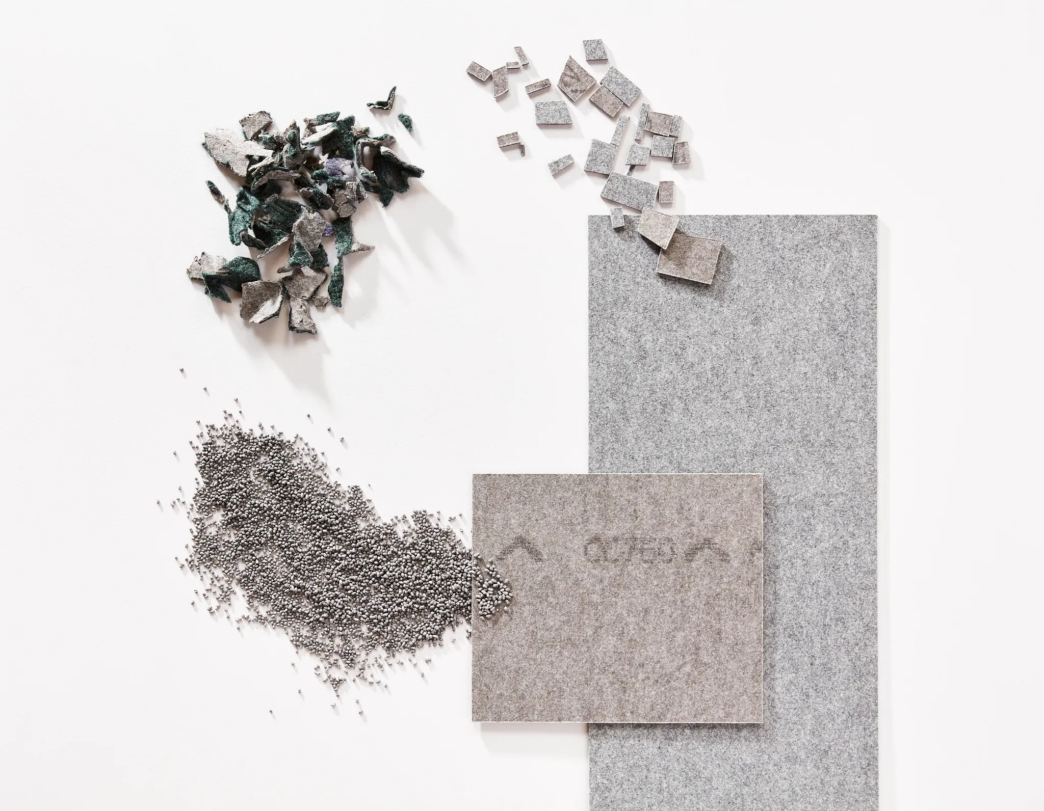 Swatch of commercial carpet tile in shades of grey with material sample
