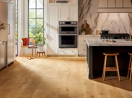 Elegant Hardwood Flooring in Stylish Kitchen Modern kitchen with natural light hardwood flooring