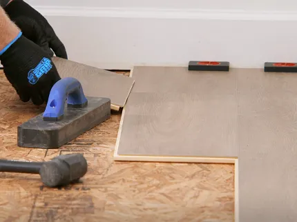 Easy to install wood look luxury vinyl plank flooring installation process Installation of wood look luxury vinyl plank flooring with tools and spacers