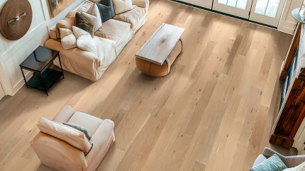Light Wood Flooring in a Cozy Living Room Setting Cozy living room with light wood flooring, beige sofa, and armchair