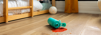 childs room with bed, doll, ball and sports bottle pilled on COREtec flooring